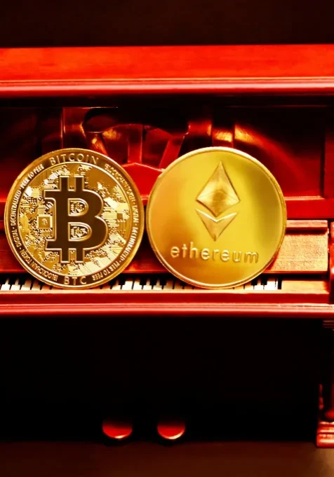 Bitcoin and Ethereum Coins on Display What is cryptocurrency? Bitcoin and Ethereum coins displayed on a miniature piano, symbolizing digital currency.